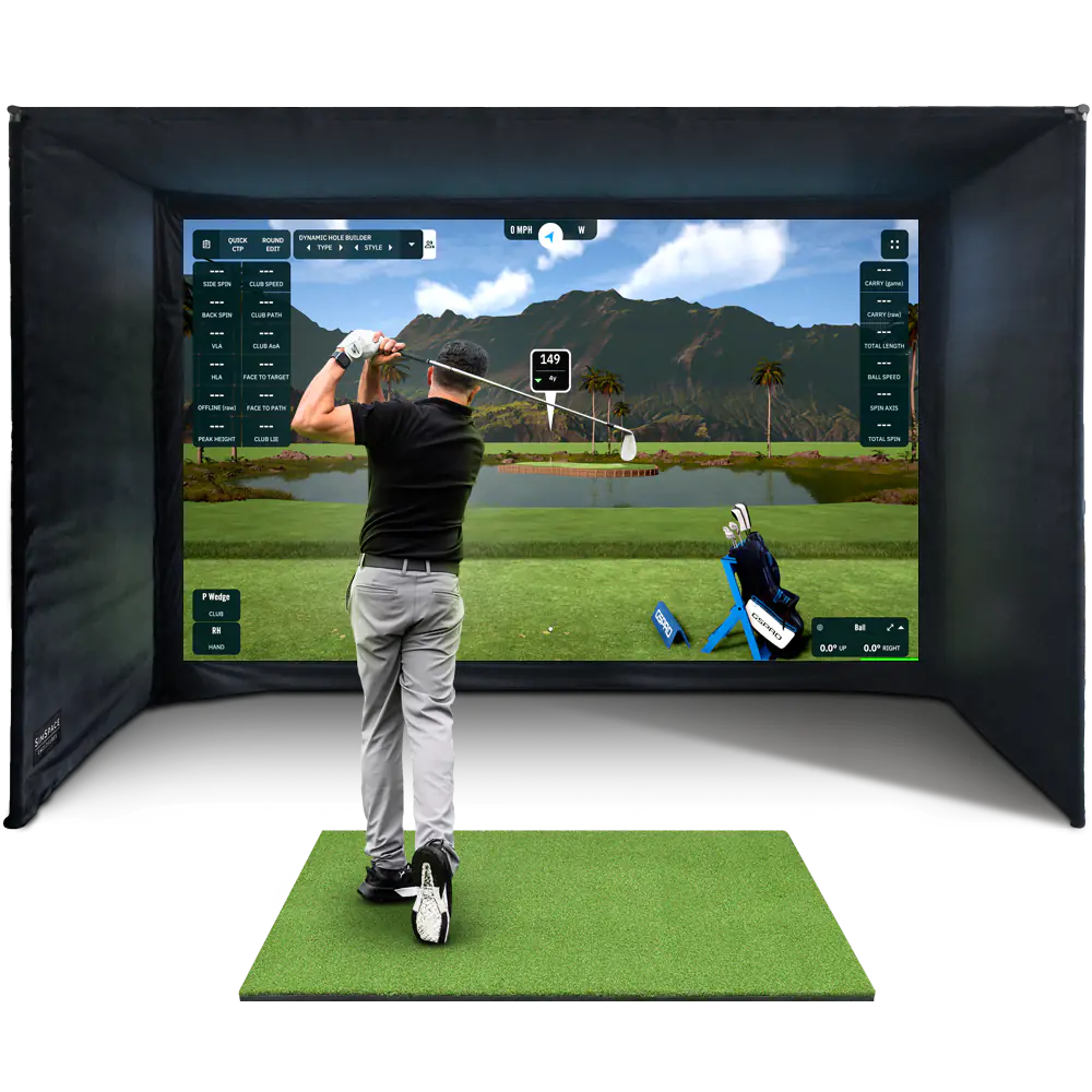 Golfer using a golf enclosure with a screen displaying a golf course.